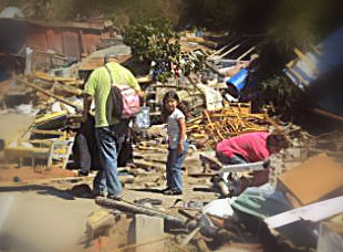 Child looking through earthquake rubble with parents