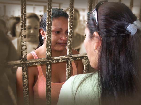 Aglow woman ministering to woman in jail